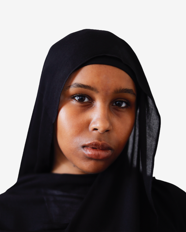 Person wearing a black hijab against a plain background